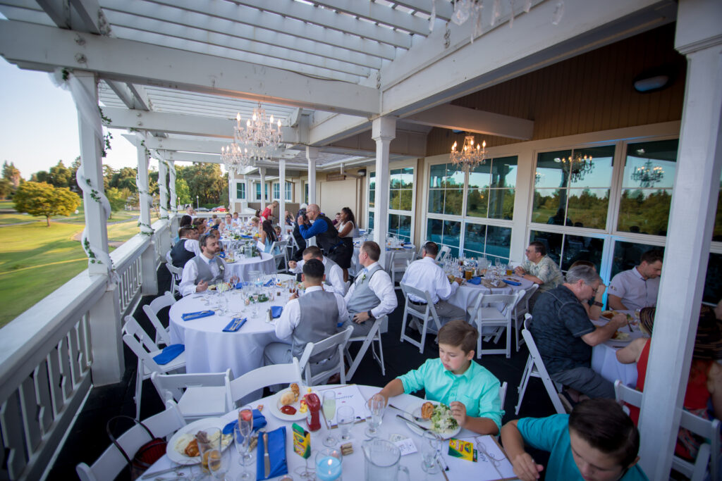 Wedding guests eating dinner on patio